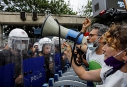 Riot police prevent protesters from marching to the scene where Turkish President Tayyip Erdogan attends the groundbreaking ceremony of Sazlidere Bridge over the planned route of Kanal Istanbul, in Istanbul, Turkey, June 26, 2021.