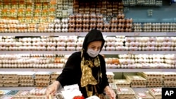 A woman shops in a supermarket in north Tehran, Iran, Sept. 25, 2021.