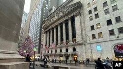 A scooter passes the New York Stock Exchange in New York's Financial District on Dec. 17, 2024.
