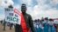 South Sudanese people hold signs as they await the arrival back in the country of South Sudan's President Salva Kiir, at the airport in Juba, South Sudan, June 22, 2018.