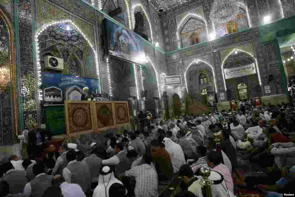Shi&#39;ite Muslims listen to Sheikh Abdul Mehdi Al-Karbala&#39;i speak as he delivers the text of a sermon by Iraq&#39;s top Shi&#39;ite cleric Grand Ayatollah Ali al-Sistani, during Friday prayers at the Imam Hussein shrine in the holy city of Karbala, Aug. 8, 2014.
