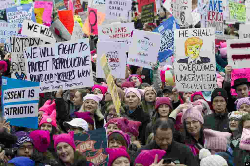 Women with pink hats and signs begin to gather early and are set to make their voices heard on the first full day of Donald Trump&#39;s presidency, Jan. 21, 2017 in Washington. (AP Photo/Jose Luis Magana)