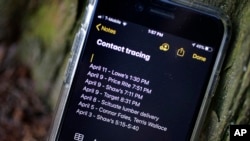 FILE - A smartphone belonging to Drew Grande of Cranston, Rhode Island, shows notes he made for COVID-19 contact tracing, April 15, 2020. 