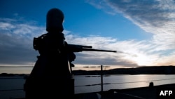 A general view of USS Mount Whitney of the US Navy at sunrise as it approaches the port during the NATO-led military exercise Trident Juncture, Nov. 3, in Trondheim, Norway.
