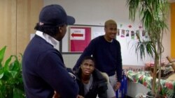 Omer Mas Capitolin, left, and youngsters at the Maison Communautaire pour le Developpement Solidaire community center in Paris. (Lisa Bryant/VOA)