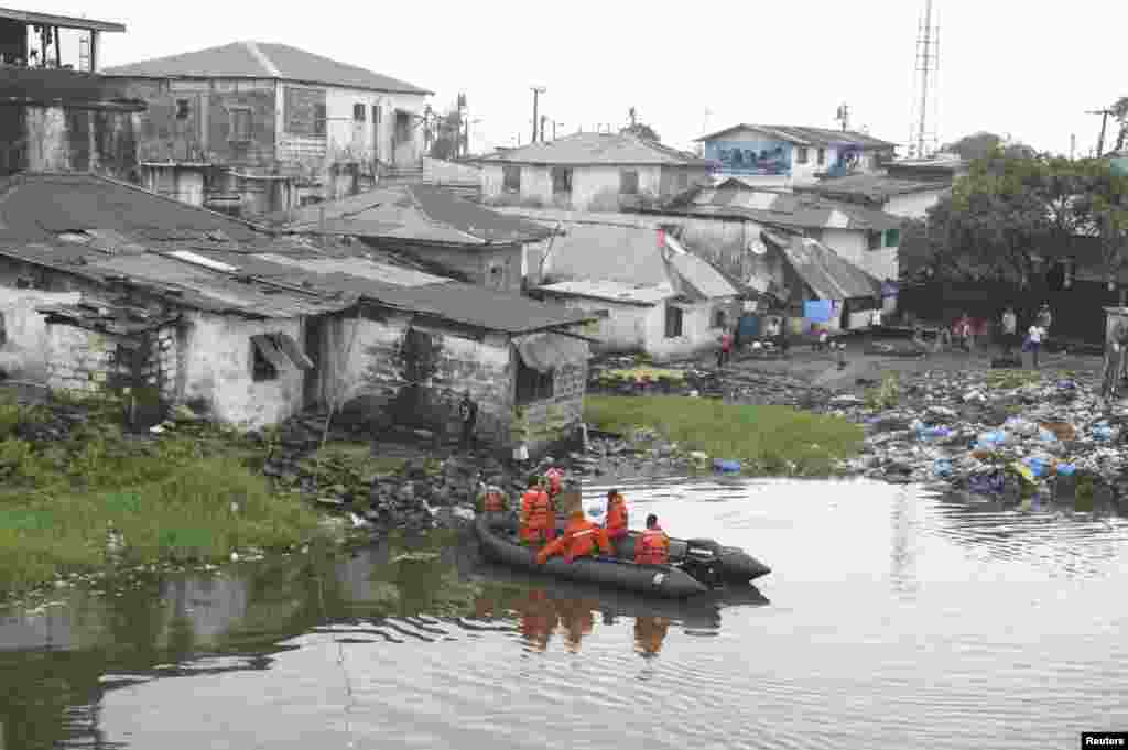 Liberian security forces patrol the waters around the Ebola quarantine area of West Point to stop residents crossing to the city center of Monrovia, Aug. 24, 2014.
