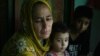 Indian Kashmiri refugee woman Nasima Bibi (L) as she sits with her granddaughter and grandson at Manak Payyan refugee camp on the outskirts of Muzaffarabad, the capital of Pakistan controlled Kashmir, Aug. 7, 2013.