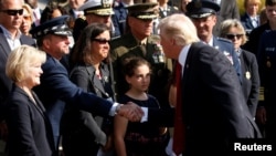 U.S. President Donald Trump shakes hands while attending the 9/11 observance at the National 9/11 Pentagon Memorial in Arlington, Virginia, Sept. 11, 2017.