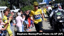 Britain's Chris Froome runs after he crashed at the end of the twelfth stage of the Tour de France cycling race.