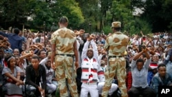 FILE - Ethiopian soldiers try to stop protesters in Bishoftu, in the Oromia region of Ethiopia, Oct. 2, 2016.