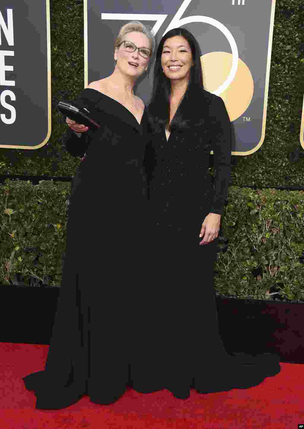 Meryl Streep, left, and Ai-jen Poo arrive at the 75th annual Golden Globe Awards at the Beverly Hilton Hotel on Sunday, Jan. 7, 2018, in Beverly Hills, Calif. (Photo by Jordan Strauss/Invision/AP)