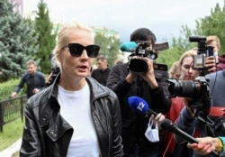 FILE - Yulia Navalnaya, wife of Russian opposition leader Alexei Navalny, speaks with the media outside a hospital, where Alexei receives medical treatment in Omsk, Russia, August 21, 2020.