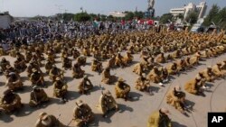 Supporters of Jamiat Ulema-e-Islam party wait for their leaders during an anti-government march, in Islamabad, Pakistan, Sunday, Nov. 3, 2019.