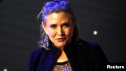 Carrie Fisher poses for cameras as she arrives at the European Premiere of "Star Wars, The Force Awakens" in Leicester Square, London, Dec. 16, 2015. 