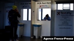 A passenger waits for a Covid-19 test at the Schiphol airport, Netherlands, Nov. 29, 2021. 
