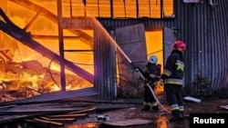Petugas sedang memadamkan kebakaran di gudang industri akibat serangan drone Rusia di Lviv, Ukraina, 19 September 2023. (Foto: via Reuters)