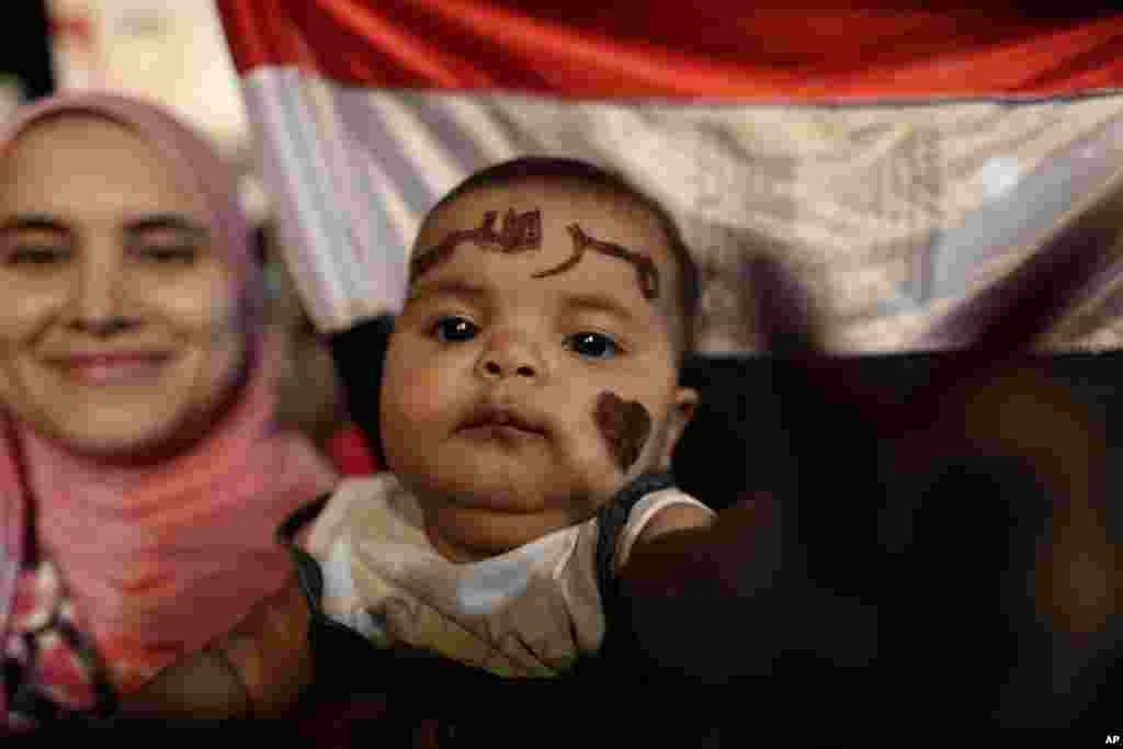 A supporter of Egypt&#39;s ousted President Mohamed Morsi cries while saluting the Egyptian flag at Rabaa al-Adawiya mosque, Nasr City, Cairo, Egypt.