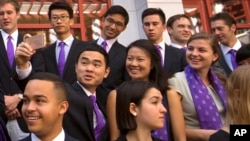 FILE - Members of the Schwarzman Scholars take a selfie as they line up for a group photo before a ceremony to officially open the scholar program at Tsinghua University in Beijing, Saturday, Sept. 10, 2016. (AP Photo/Mark Schiefelbein)