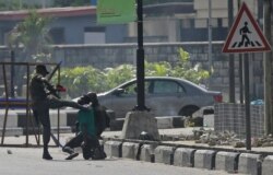 Police officers detain a protester at the Lekki toll gate in Lagos, Nigeria, Oct. 21, 2020.