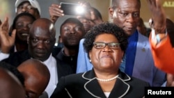 Zimbabwe's former vice president Joice Mujuru (c) smiles while addressing supporters in Harare, March 1, 2016.
