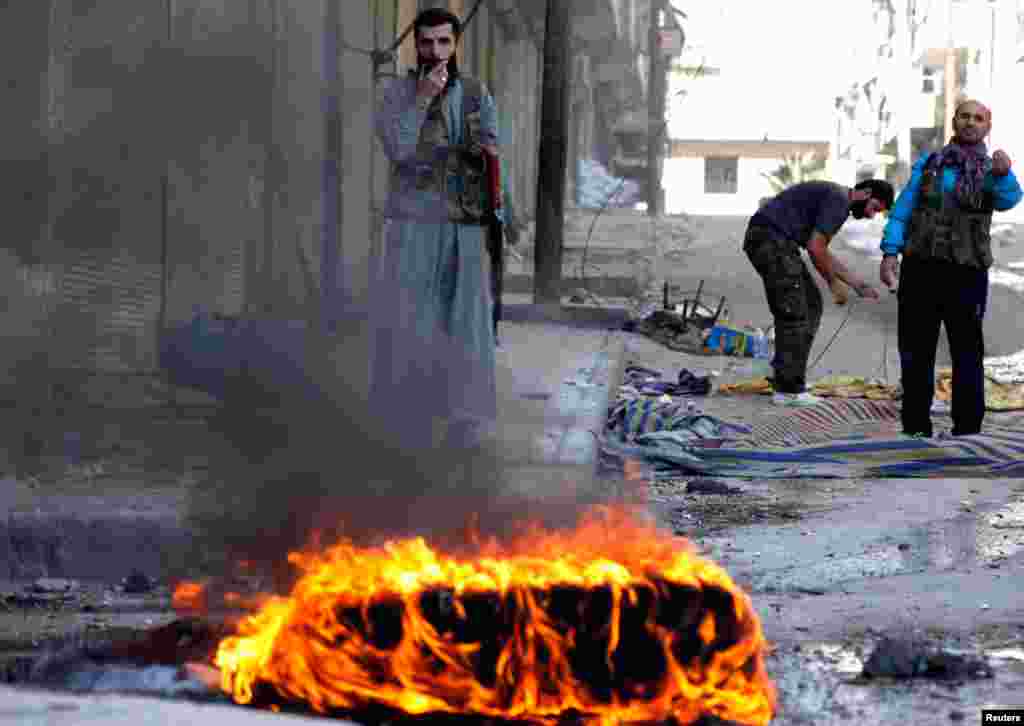 Free Syrian Army fighters are seen on the front line in Aleppo's Bustan Al-Basha district in Syria, October 15, 2012.