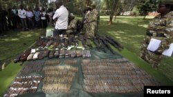 Kenya wildlife officials display firearms recovered from elephant poachers at their headquarters, Nairobi, June 22, 2012.