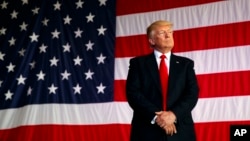 FILE - President Donald Trump is introduced to speak to U.S. military troops at Naval Air Station Sigonella, Italy.