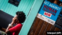 FILE - A prostitute is shown being questioned during a raid in night clubs in Georgetown, Guyana, April 7, 2018. A 13-country police operation freed nearly 350 people from human trafficking networks and arrested 22 people across the Caribbean and South America.