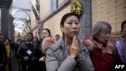 Chinese Christians attend Christmas Eve mass at a Catholic church in Beijing, on Dec. 24, 2016.
