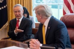 FILE - China's Vice Premier Liu He speaks with U.S. President Donald Trump during a trade meeting in the Oval Office at the White House in Washington, April 4, 2019.