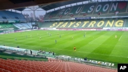 Players of Jeonbuk Hyundai Motors FC and Suwon Samsung Bluewings play during the opening game of South Korea's K-League football match at the Jeonju World Cup Stadium in Jeonju, South Korea, May 8, 2020.