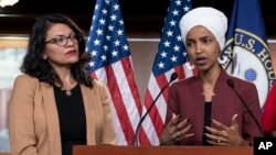 In this July 15, 2019, file photo, U.S. Rep. Ilhan Omar, right, speaks, as U.S. Rep. Rashida Tlaib listens, during a news conference at the Capitol in Washington, D.C. (AP Photo/J. Scott Applewhite, File)