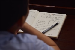 This photo taken on June 26, 2019, shows an adult student taking notes on Xi Jinping taught in a class at the Party School of the Chinese Communist Party's Central Committee for foreign journalists in Beijing.