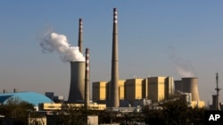 FILE - Smoke billows from a coal-fired power plant in Beijing, China, Nov. 13, 2014.