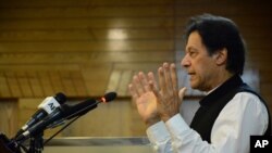 Pakistani Prime Minister Imran Khan addresses Kashmir's Legislative Assembly on the occasion of Pakistan's Independence Day, in Muzaffarabad, capital of Pakistani Kashmir, Aug. 14, 2019. 