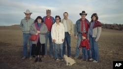 FILE - Members of the "Save Boyd County Association," pose near Spencer, Neb., early in 1989 to oppose the prospect of a nuclear waste dump in their county. These protests are usually referred to as NIMBY. (AP Photo/Tad Bartimus)