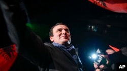 FILE - Albin Kurti, leader of the Self-Determination movement (Vetevendosje), arrives to address a celebrating crowd in the Kosovo capital of Pristina, early Monday, Oct. 7, 2019. 