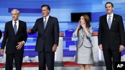 U.S. Republican presidential candidates Ron Paul (L), Mitt Romney (2nd L), Michele Bachmann and Tim Pawlenty (R) gather before the start of their debate in Ames, Iowa August 11, 2011.