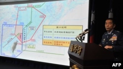 FILE - Air Force Lieutenant General Liu Shou-Jen introduces a map of Air Defense Identification Zone (ADIZ) in the East China Sea during a press conference in Taipei, Taiwan, Dec. 2, 2013. Taiwan said its military planes have made about 30 flights into a part of China's newly declared air defense zone, which overlaps a similar Taiwanese zone.