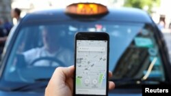 A Palestinian man rides his donkey cart past a building that was destroyed during the 11-day war in May of this year between Israel and the Palestinian Hamas movement, in Gaza City.
