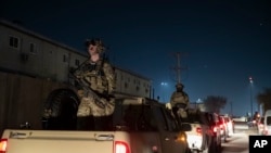 FILE - In this Nov. 28, 2019, file photo armed soldiers stand guard at Bagram Air Field, Afghanistan. (AP)