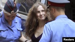 A worker carries bunches of bananas on his shoulder after being unloaded from a ship at a jetty in Rangoon, Burma.