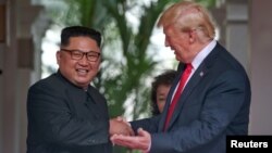U.S. President Donald Trump meets North Korean leader Kim Jong Un at the Capella Hotel on Sentosa island in Singapore, June 12, 2018. 