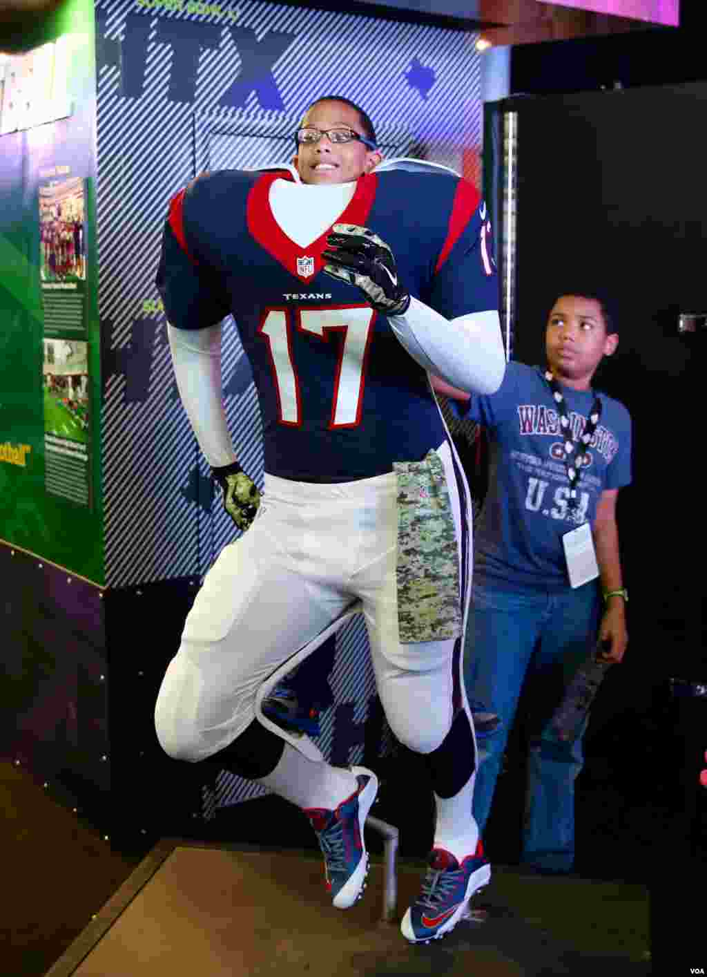 A young fan pretends to be a player on his favorite team, the Houston Texans, at the NFL Experience in downtown Houston. The Super Bowl, the NFL championship game and most watched football game worldwide, will be played here on Sunday, February 5th. (B. A