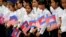 FILE PHOTO - Students from a local high school carry the U.S. national flags and Cambodia's national flags in Siem Reap, Cambodia, Saturday, March 21, 2015. (AP Photo/Wong Maye-E)