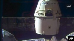FILE - In this frame grab taken from NASA Television, a SpaceX Dragon capsule separates from a robotic arm of the International Space Station en route back to Earth with a load of science experiments and gear from the space station, Aug. 26, 2016. 