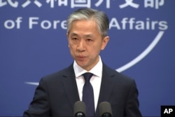 FILE - Chinese Foreign Ministry spokesman Wang Wenbin speaks during a press conference in Beijing, Nov. 13, 2020.
