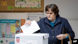 A voter casts her ballot at a polling station in Zagreb, Croatia, Dec. 22, 2019. 