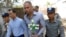Philip Blackwood, second right, general manager of VGastro Bar, walks with bar owner Tun Thurein, second left, and its manager, Htut Ko Ko Lwin, seen behind Blackwood, upon arrival for their trial at a township court, Feb. 17, 2015.