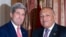 U.S. Secretary of State John Kerry, left, greets Egypt's Foreign Minister Sameh Shoukry in Cairo October 12, 2014.